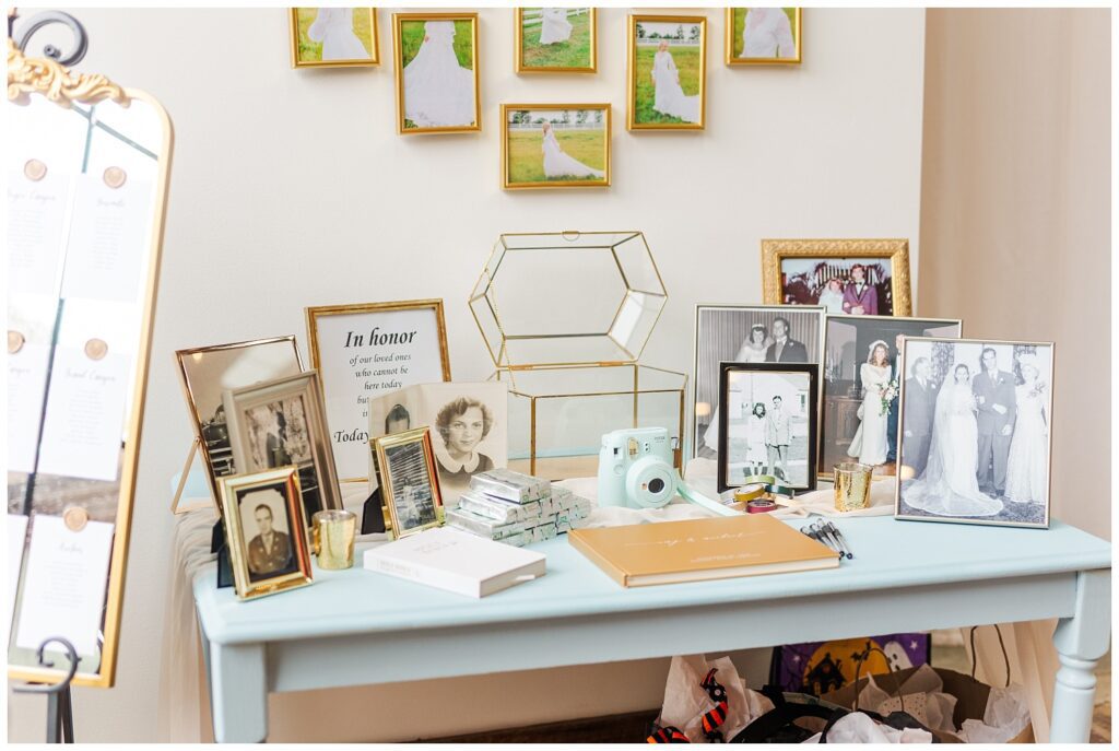 guest book next to framed photos of loves ones at fall wedding reception