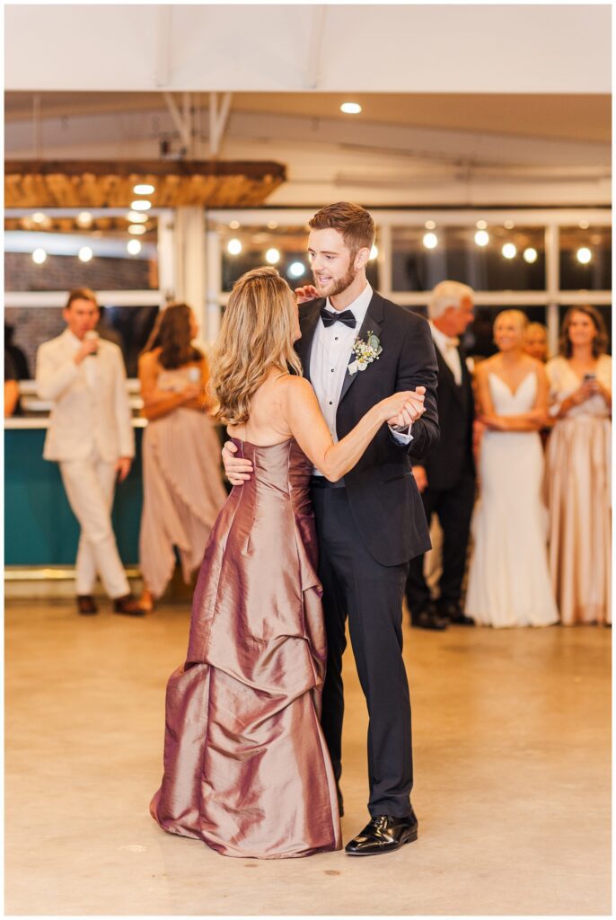 groom shares dance with his mom at fall wedding reception in Raleigh