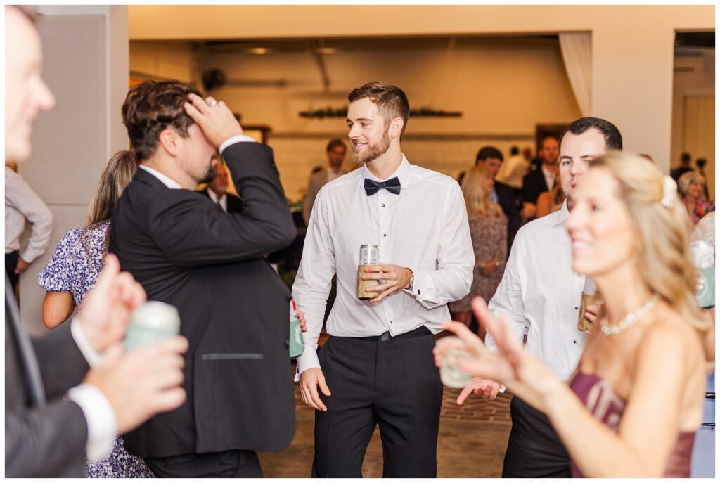groom dancing with friends at fall wedding reception in Raleigh