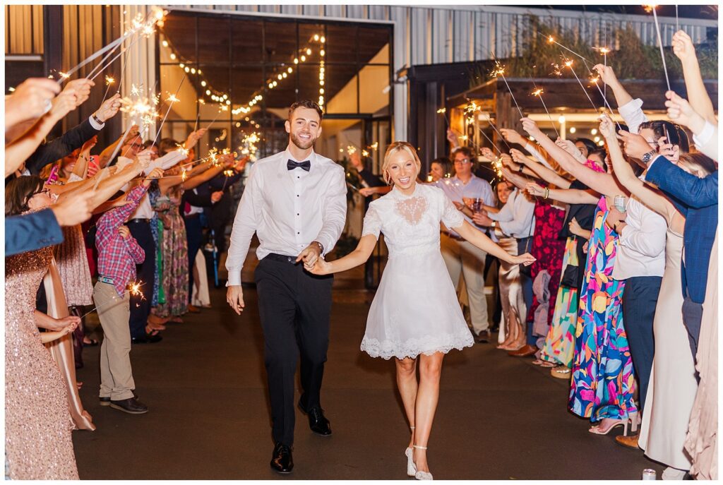 bride and groom leave venue during sparkler exit in Raleigh, NC