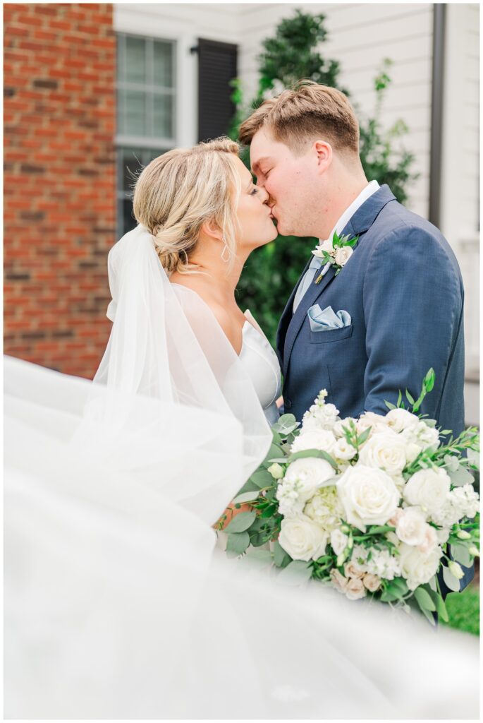 bride and groom share a kiss outside at Richmond VA wedding venue