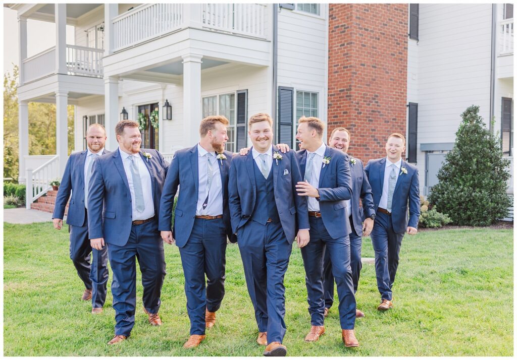 groomsmen walking and laughing together at Richmond VA wedding venue