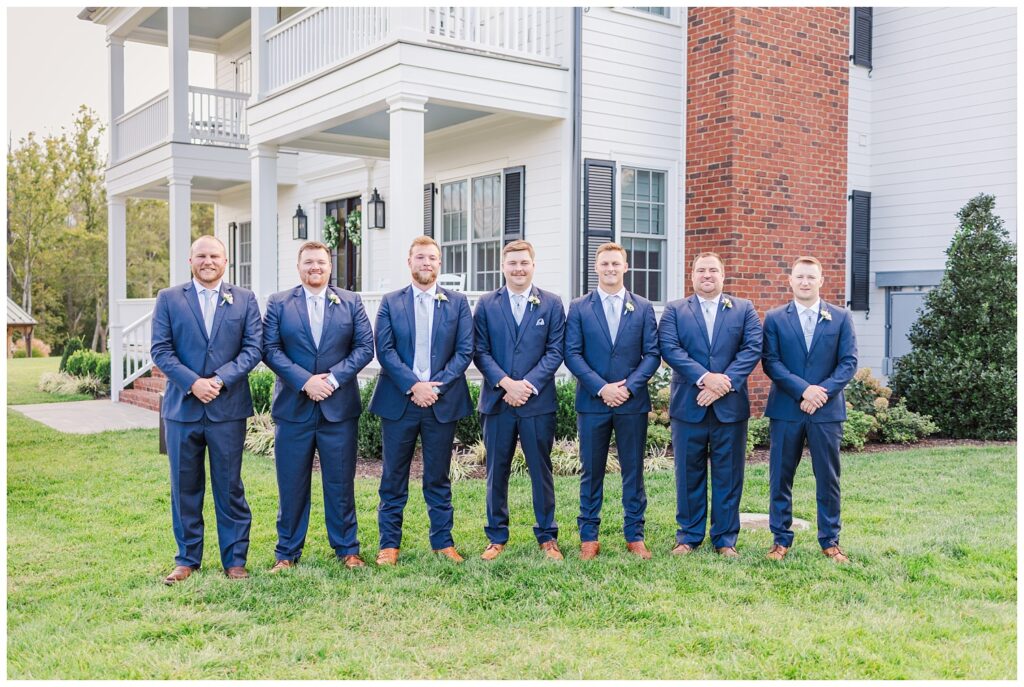 groomsmen all lined up in a row in front of Richmond VA wedding venue