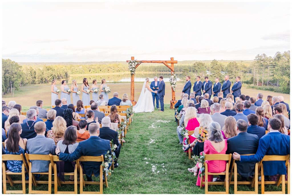 wide view of fall wedding ceremony on top of a hill in Richmond VA