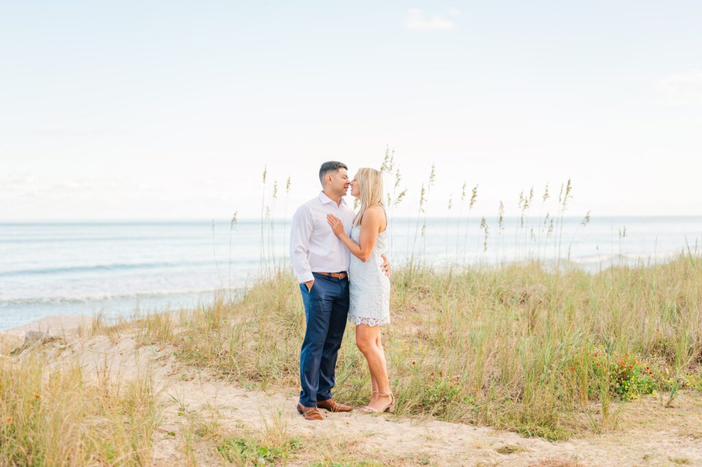 couple standing among the grass on the beach at Fort Fisher