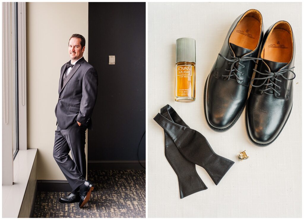 flat lay of groom's black shoes, tie, cufflinks and cologne sitting on a ivory mat