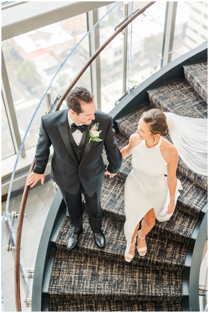 wedding couple walking down the stairs at the City Club Raleigh downtown