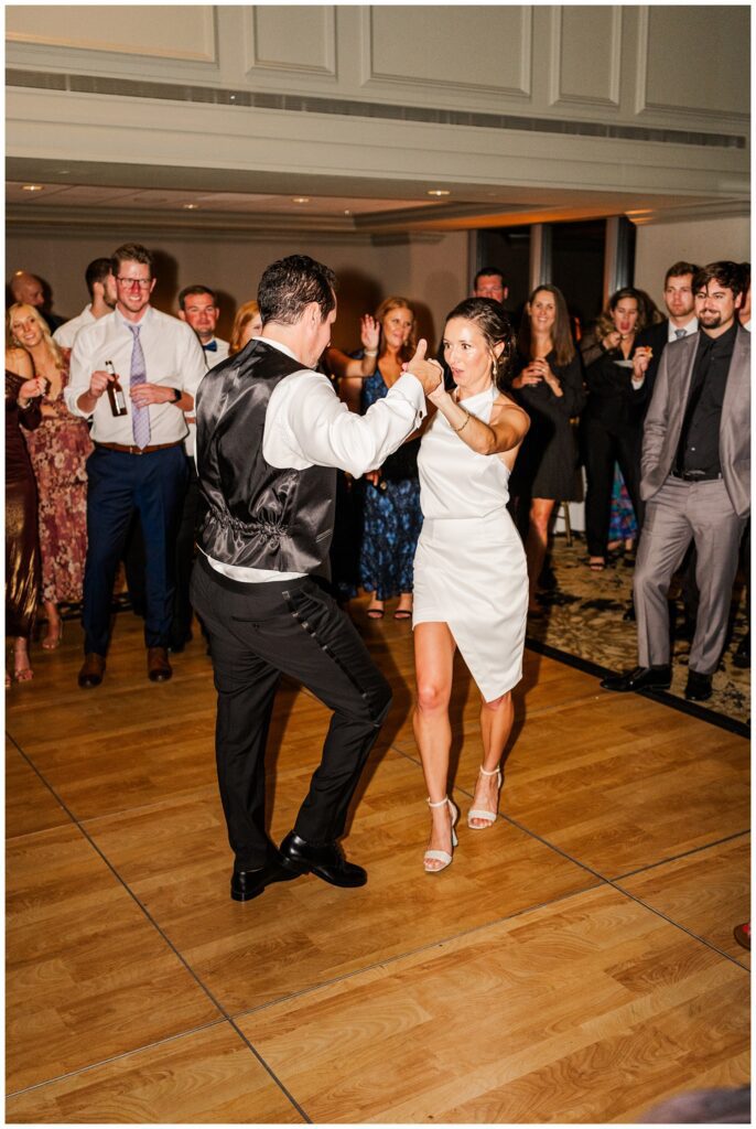 bride wearing shorter reception dress and dancing with the groom at Raleigh NC reception venue