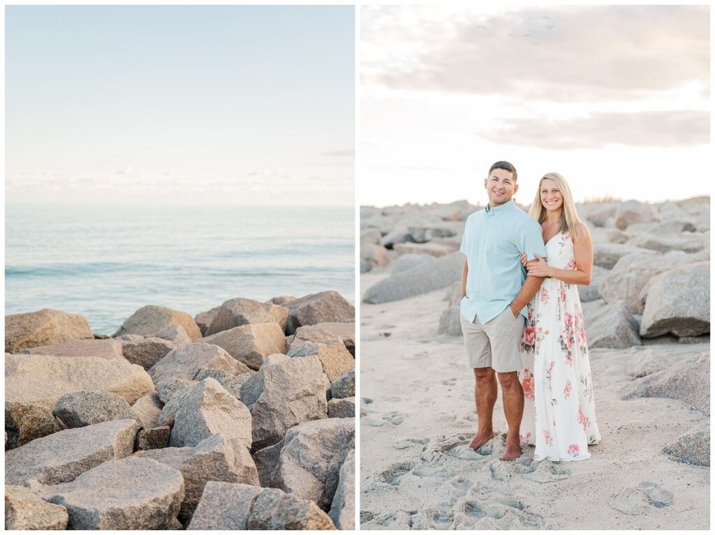 engaged couple standing on the sand next to large rocks on Fort Fisher beach