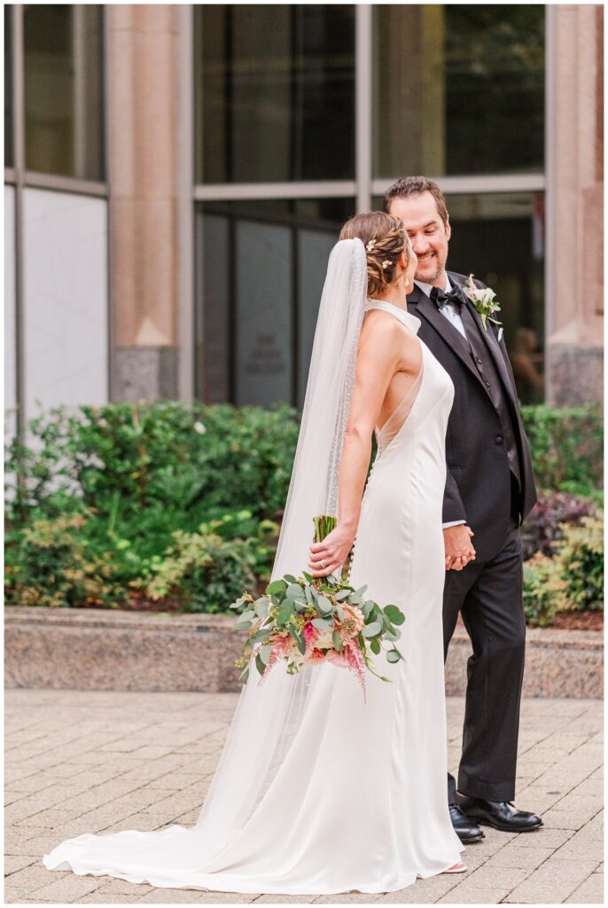 bride posing with groom outside near the City Club Raleigh wedding venue