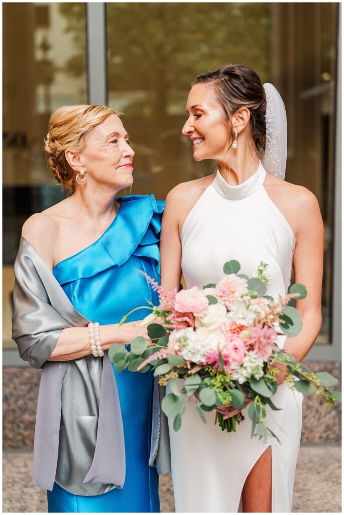 bride posing with her mom at downtown Raleigh NC wedding 
