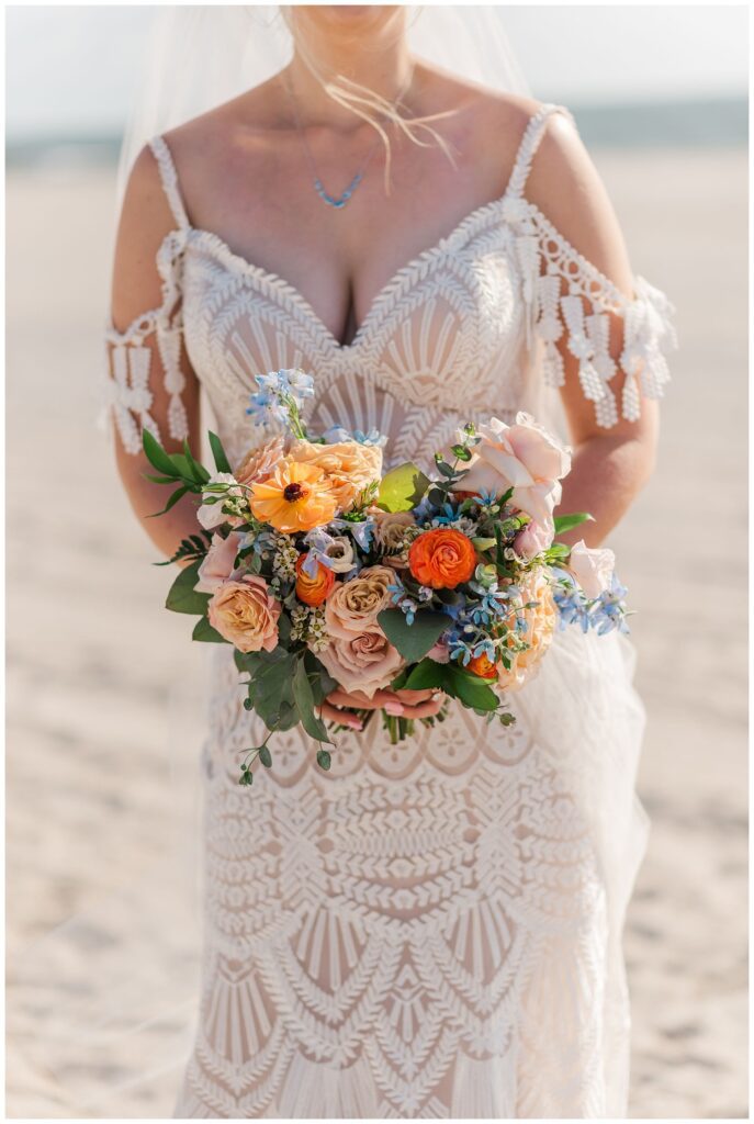 bride holding her bright colored bouquet made by Serendipity Floral Designs