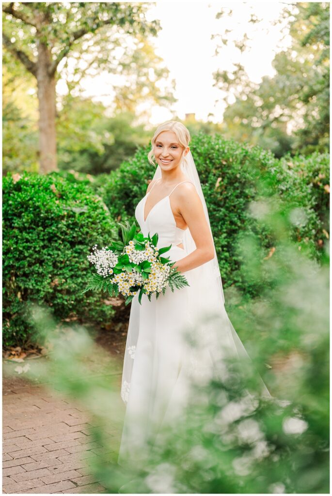 bride wearing a white spaghetti strap wedding dress at Meredith College