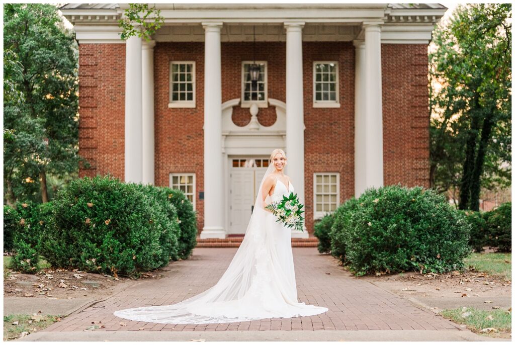 Raleigh, NC bride posing in front of a college building for portrait session