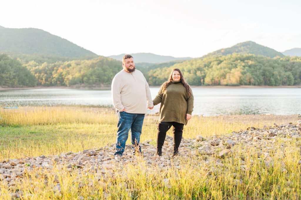 engaged couple standing on rocks at Carvins Cove