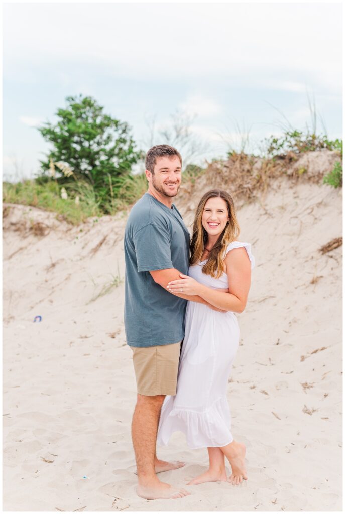 Wrightsville Beach engagement photographer standing on the sand