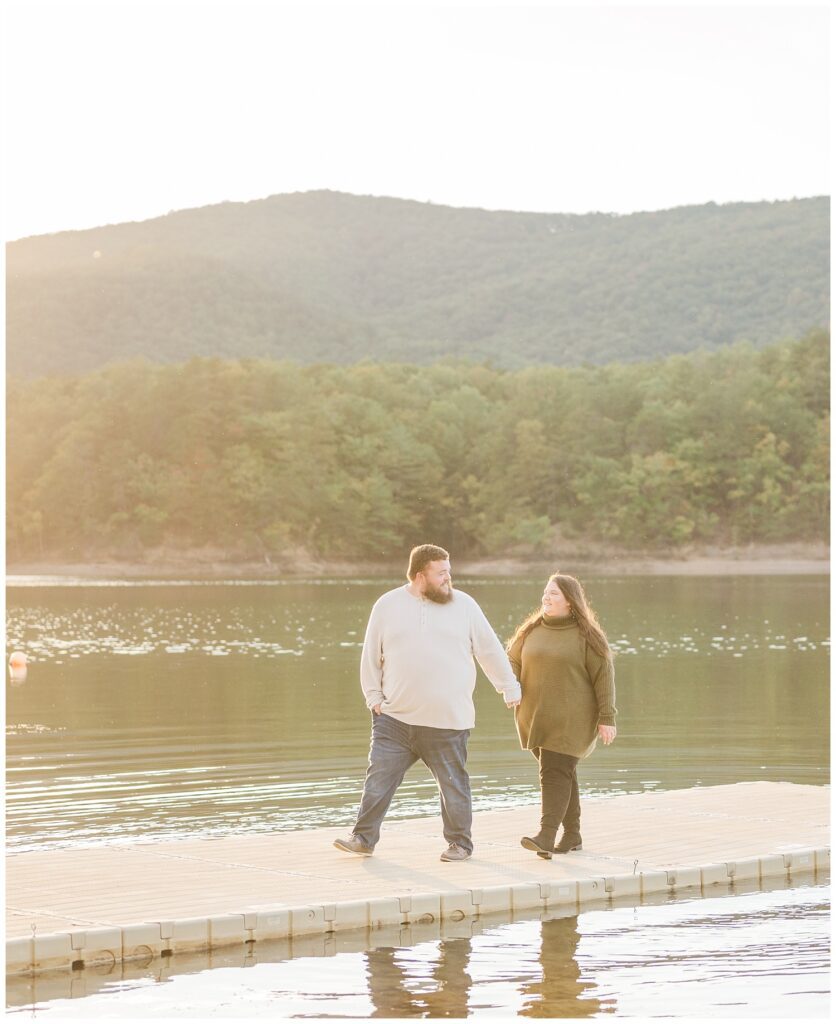 engaged couple walking on the dock at Carvins Cove in Roanoke, VA