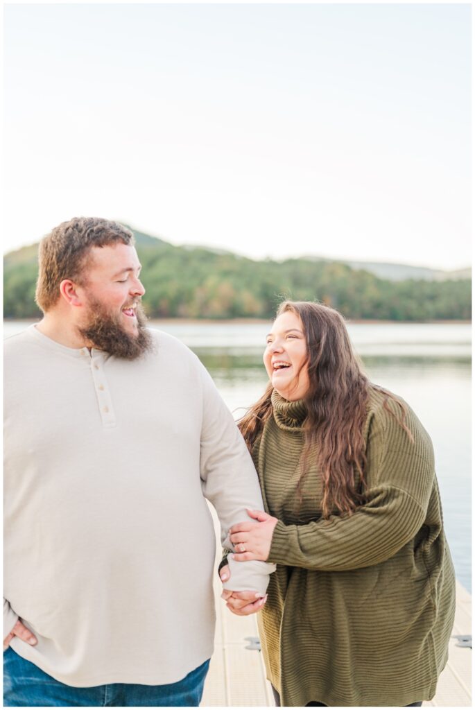 couple laughing together on the lake at Carvins Cove engagement session