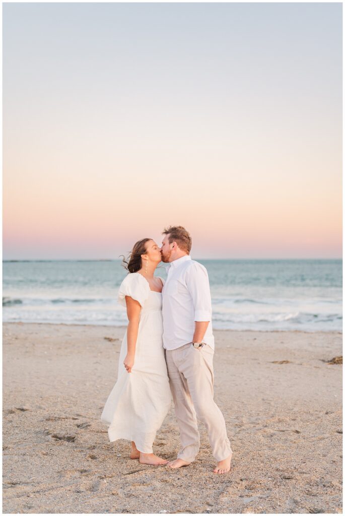 couple sharing kiss at sunset for Wrightsville Beach engagement session