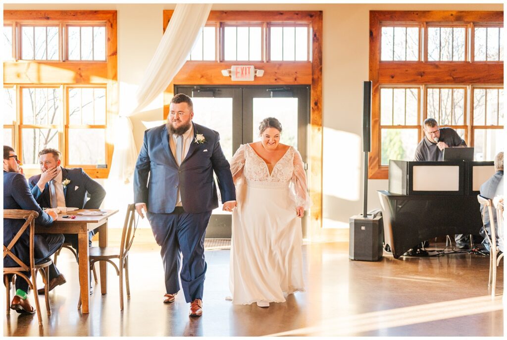 bride and groom making their entrance into the reception at Glass Hill Venue