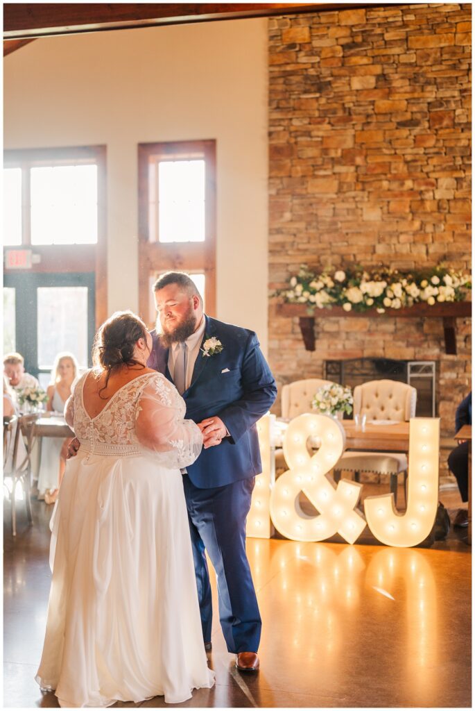 bride and groom have first dance at reception hall at Virginia wedding venue