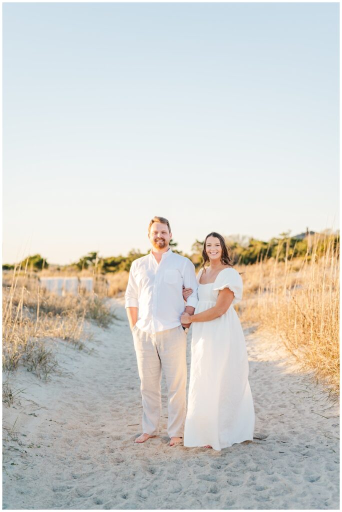 couple wearing khaki and white while standing on Wrightsville Beach