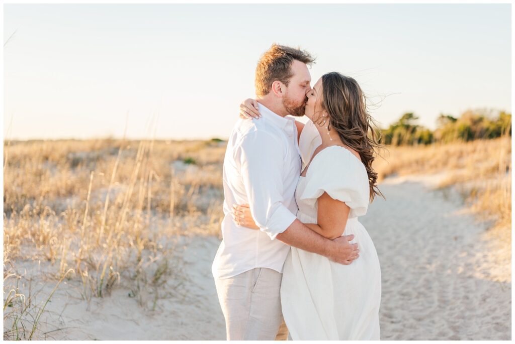 engagement couple kissing on the sand at Wrightsville Beach