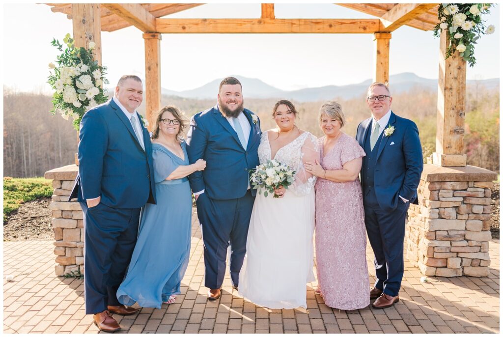 family formals with both sets of parents outside at the Glass Hill Venue