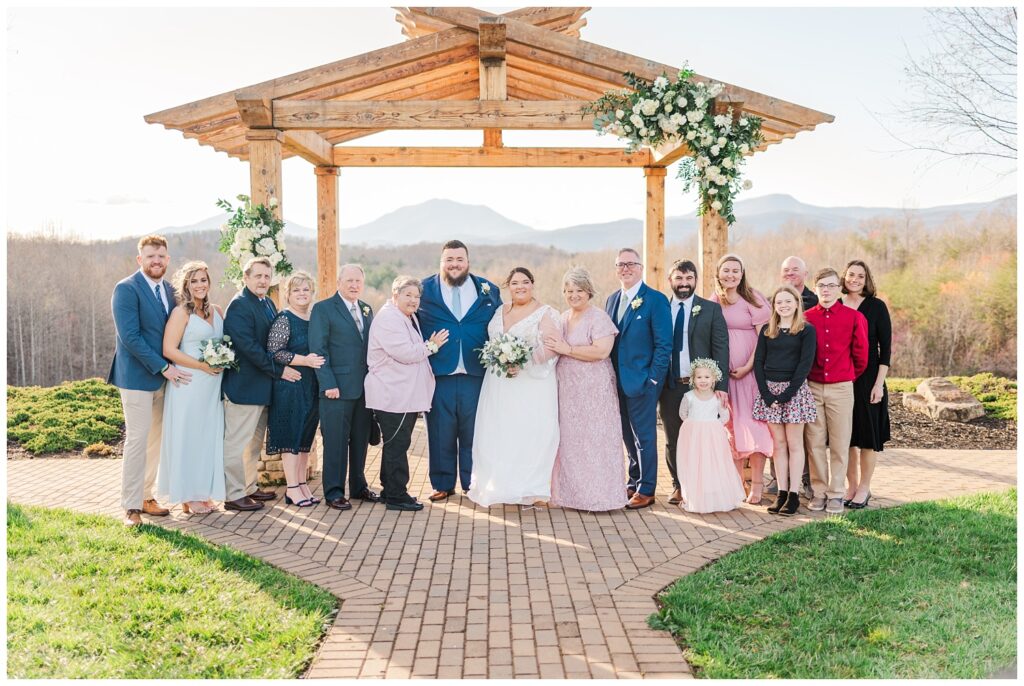 family formals with bride and groom outside at the Glass Hill Venue