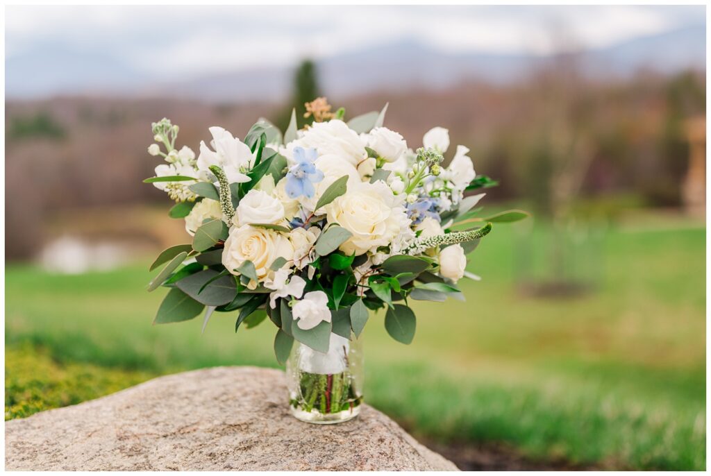 bride's bouquet sitting in a vase on a rock at Virginia wedding venue