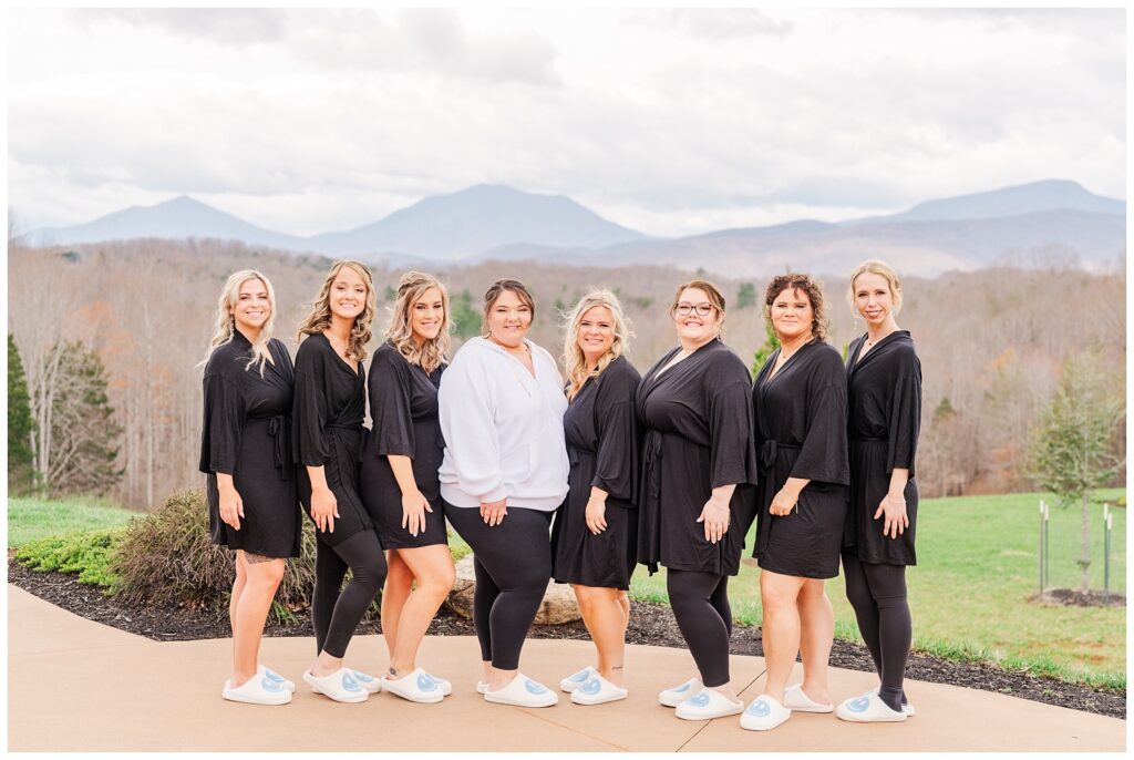 bride posing with her bridal party while getting ready