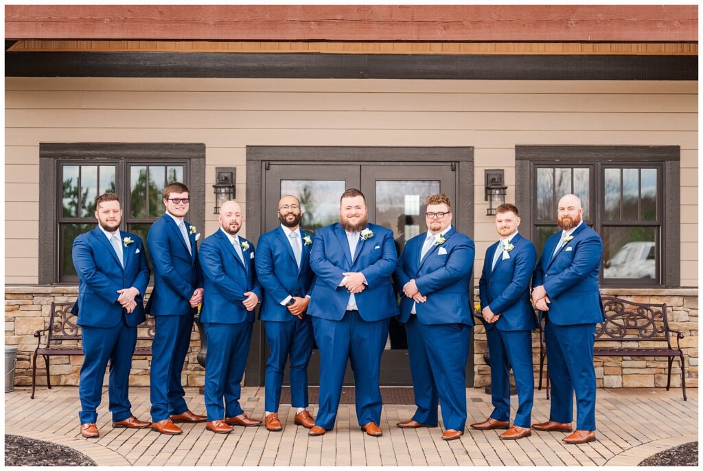 groomsmen posing at the front of the wedding venue in Virginia