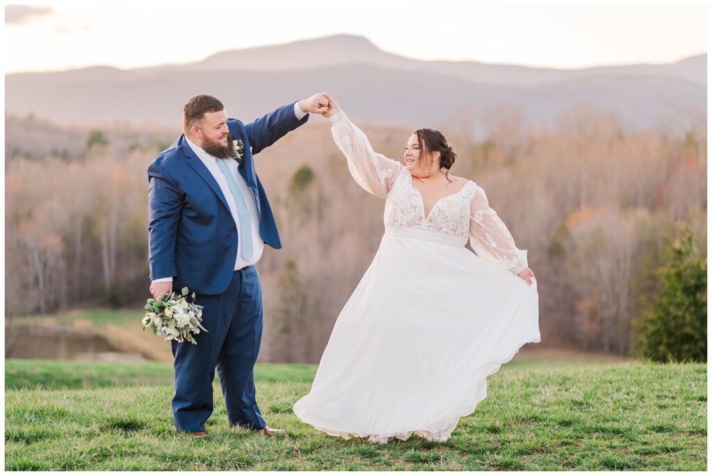 groom twirling the bride around the Virginia wedding venue grounds 