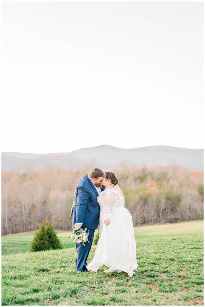 wedding couple sharing a kiss in front of the Blue Ridge Mountains in Virginia 