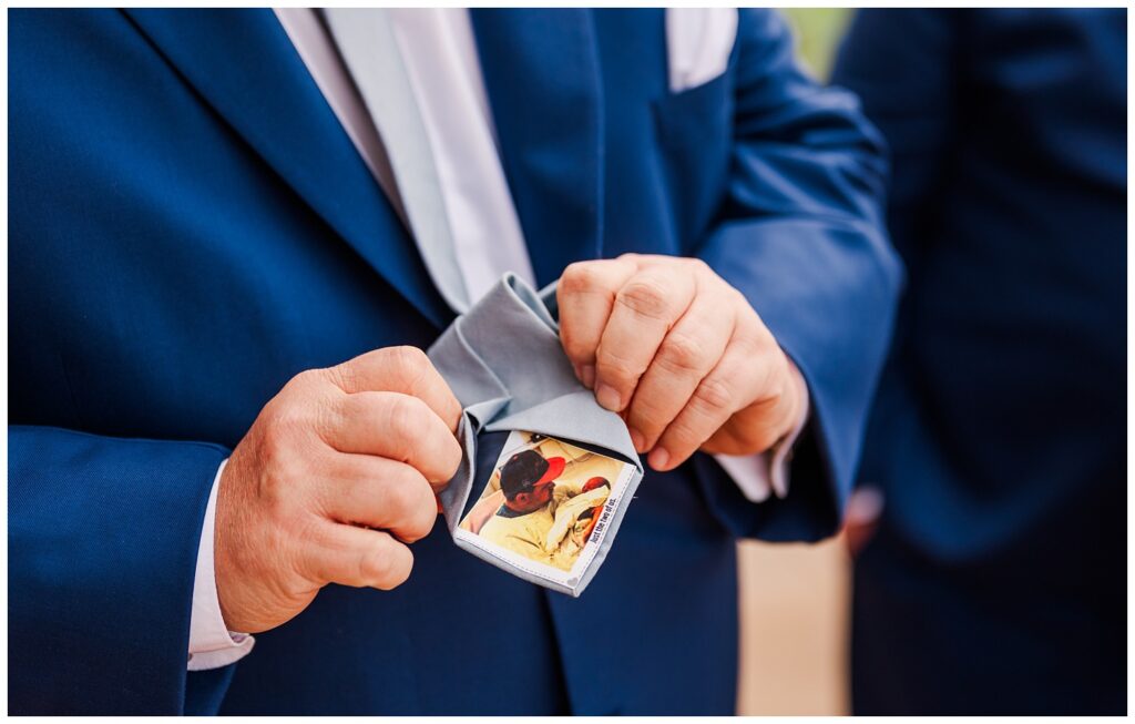 groom's dad showing his tie with his son's picture on it