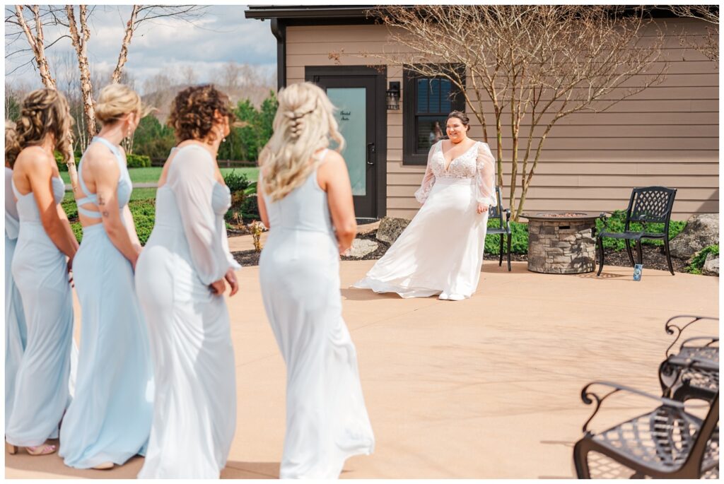 bride having a first look with the bridesmaids at the Glass Hill Venue