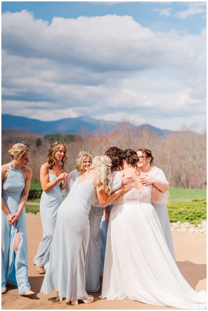 bride having a first look with the bridesmaids at the Glass Hill Venue