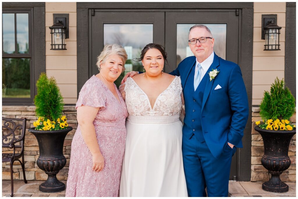 bride posing with her parents before the wedding ceremony in Virginia