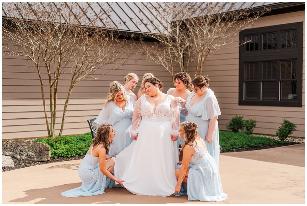 bridesmaids adjusting the bride's wedding dress at Glass Hill Venue in Virginia