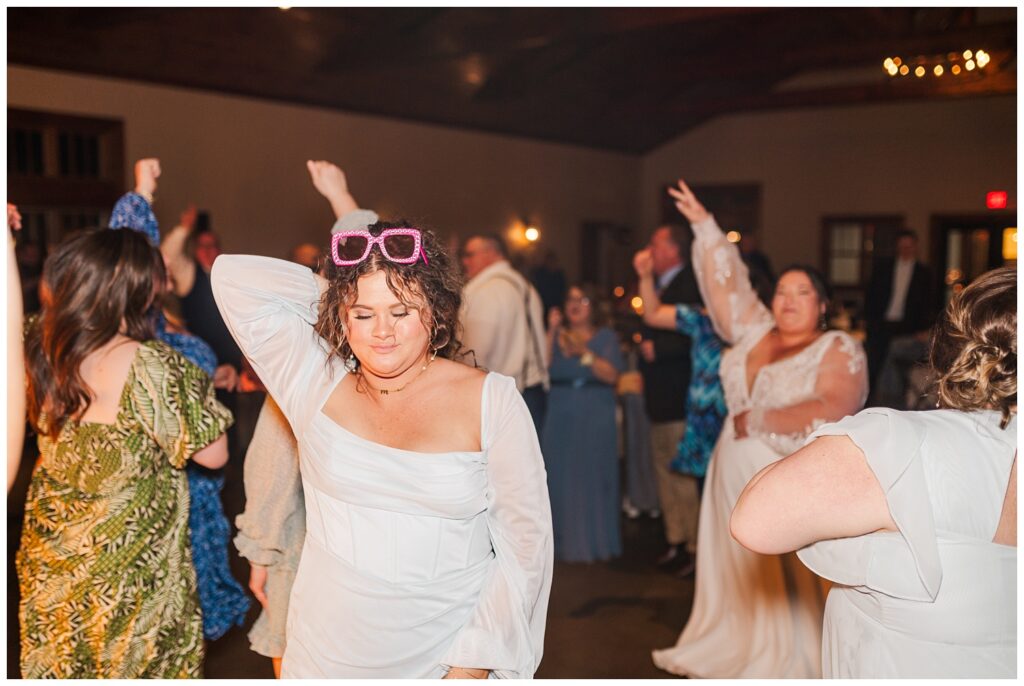 wedding reception guests dancing with the bride and groom at Glass Hill Venue