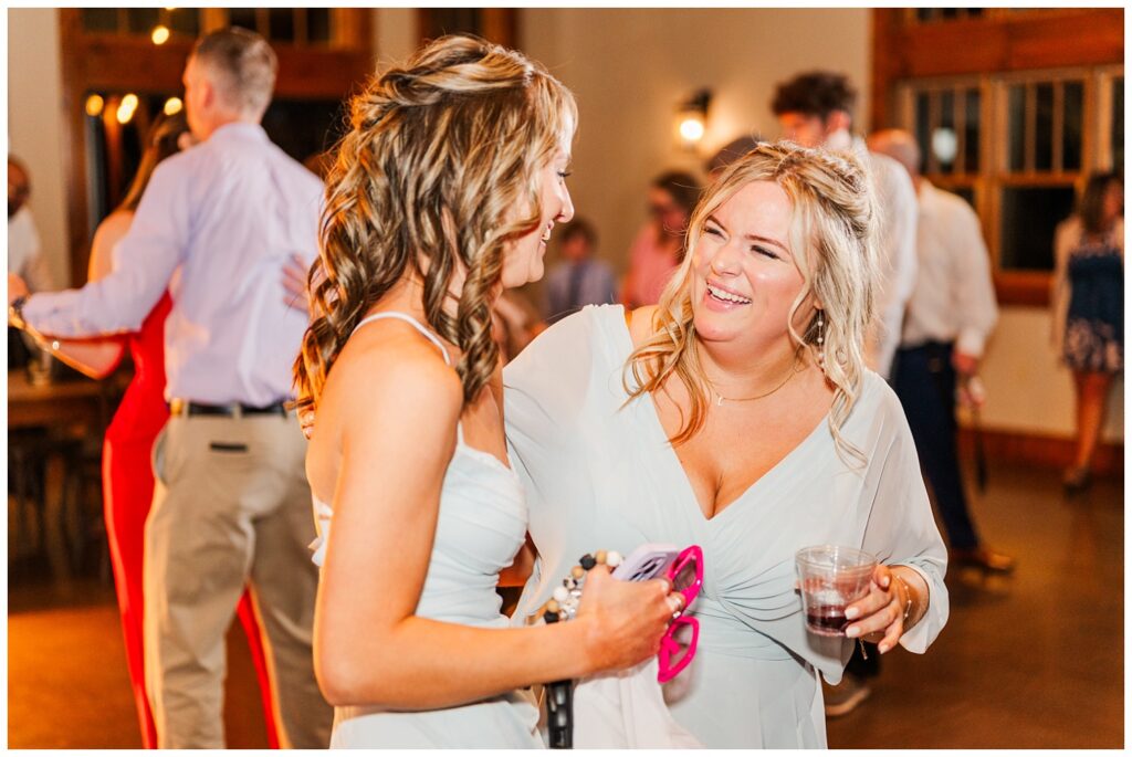 bridesmaids laughing together on the dance floor at Virginia wedding reception