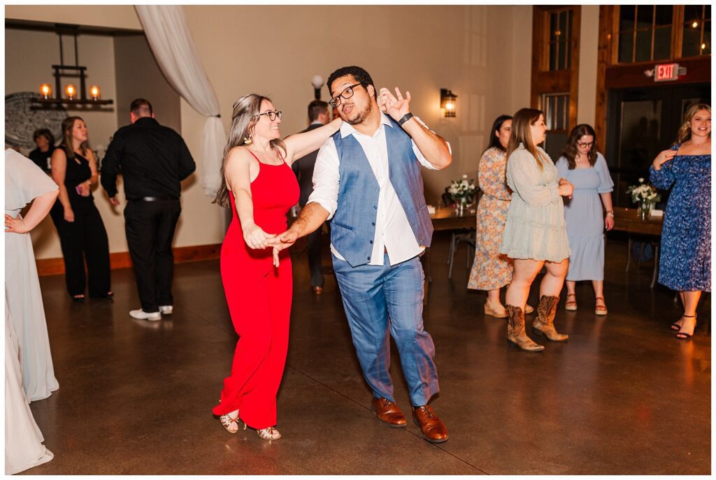 wedding reception guests dancing with the bride and groom at Glass Hill Venue