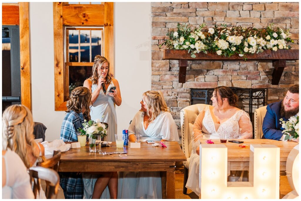 maid of honor giving wedding toast at spring reception at the Glass Hill Venue