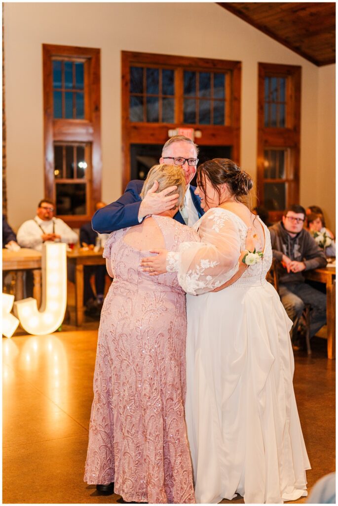 bride dancing with both of her parents at the wedding reception in Virginia 