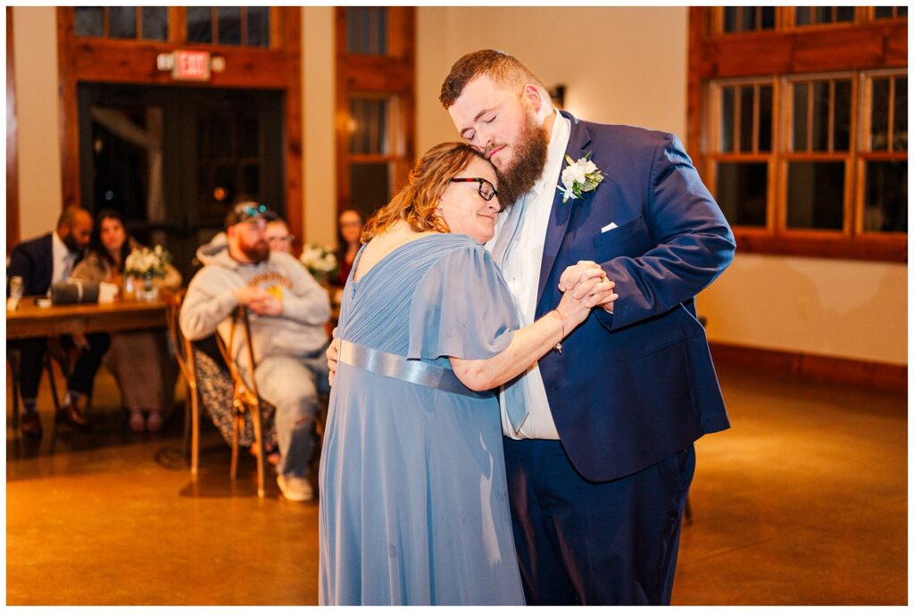 groom dancing with his mom at the wedding reception at Glass Hill Venue