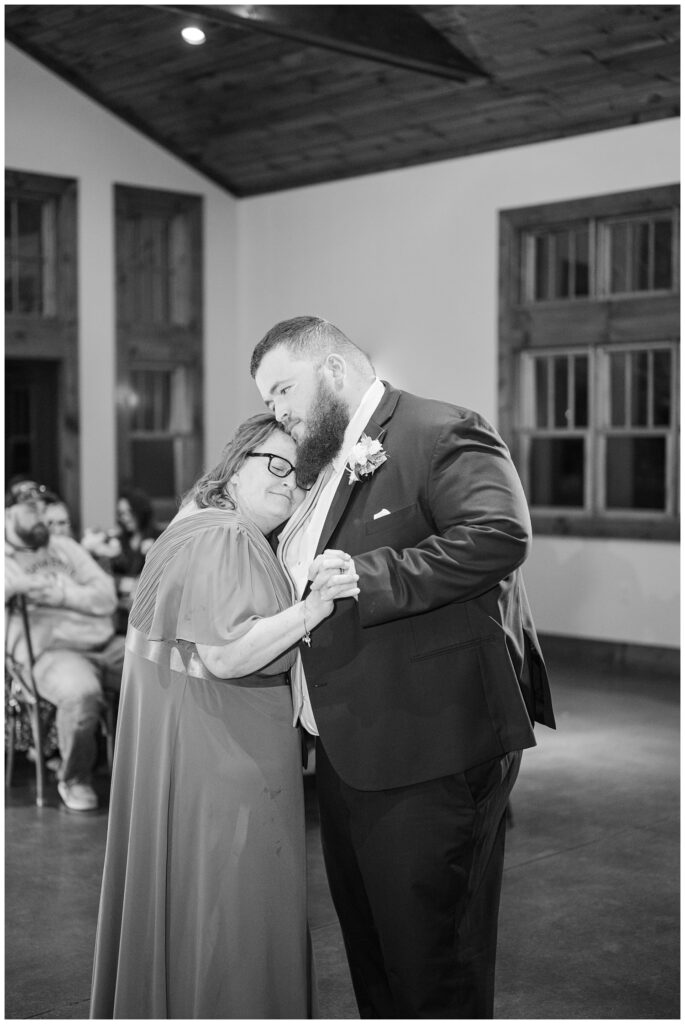 groom dancing with his mom at the wedding reception at Glass Hill Venue