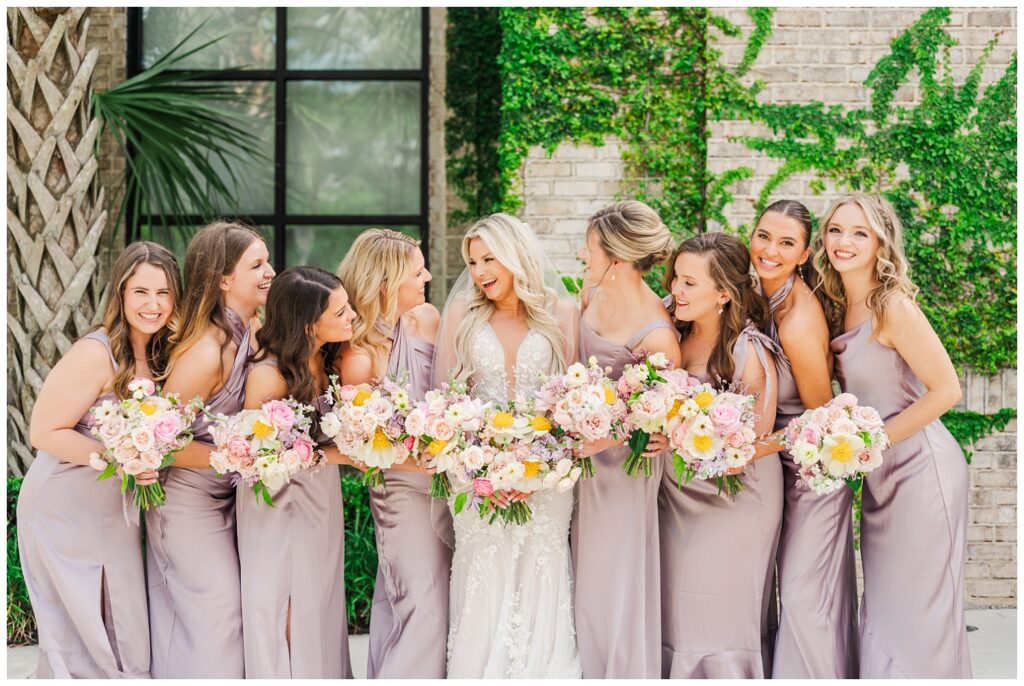 bride laughing and smiling with her bridesmaids at Wilmington spring wedding