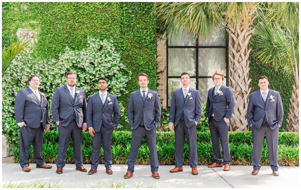 groomsmen posing together outside the wedding venue in Wilmington