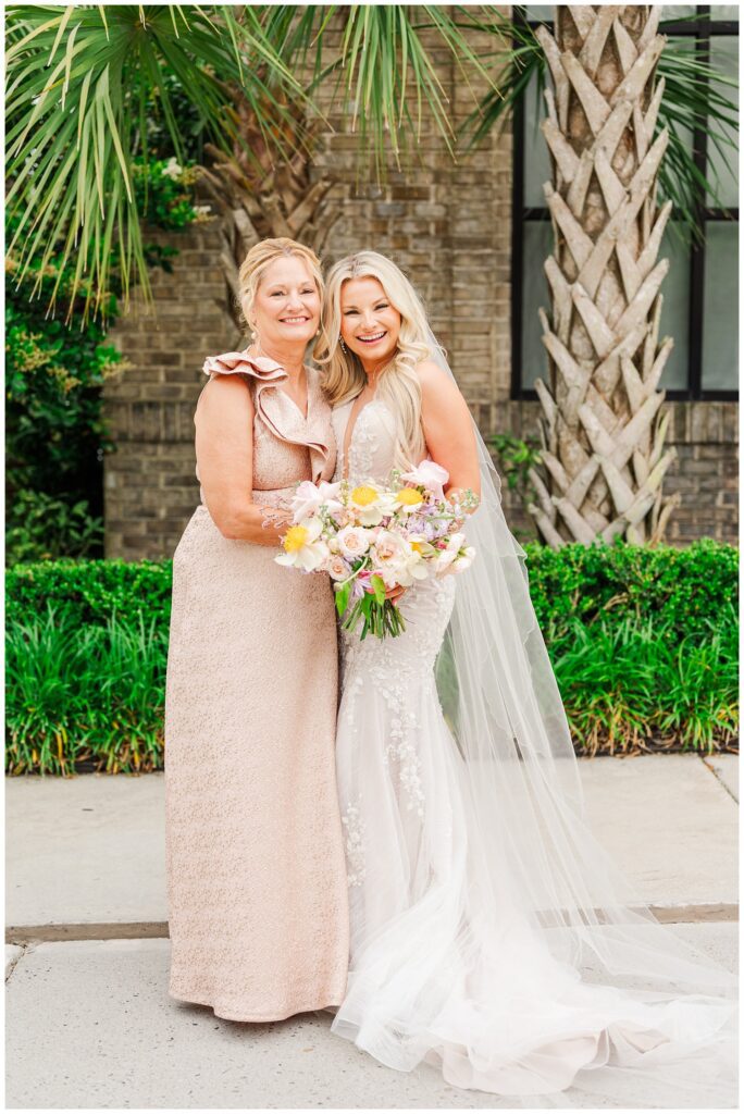 bride posing with her mom before the ceremony at Wrightsville Manor