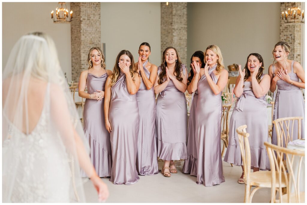 bride having a first look with her bridesmaids inside the venue at Wrightsville Manor